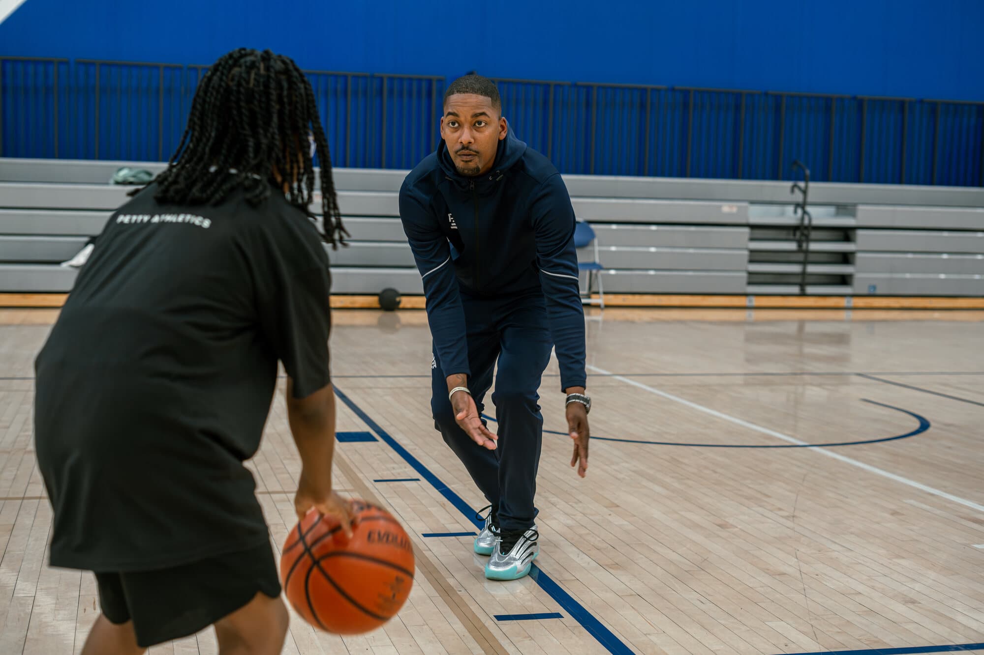 Rashad Petty coaching a youth athlete during a ball-handling drill